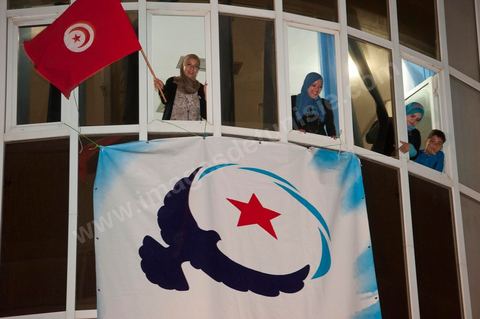 A crowd gathers in front of the Ennahdha party headquarters on election night.
