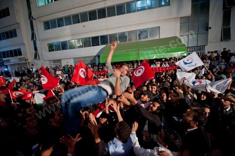 A crowd gathers in front of the Ennahdha party headquarters on election night.