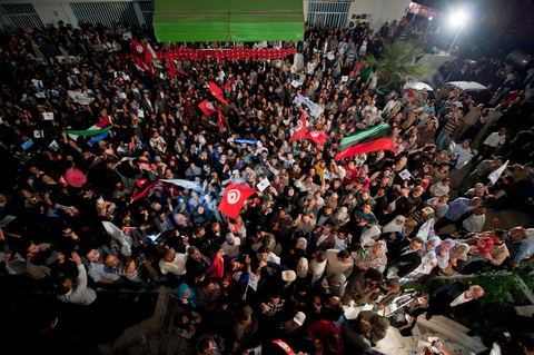 A crowd gathers in front of the Ennahdha party headquarters on election night.