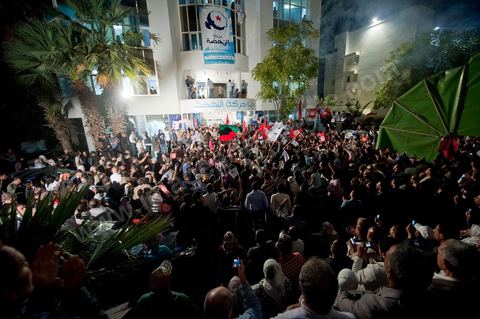 A crowd gathers in front of the Ennahdha party headquarters on election night.