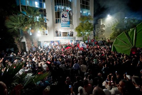 A crowd gathers in front of the Ennahdha party headquarters on election night.