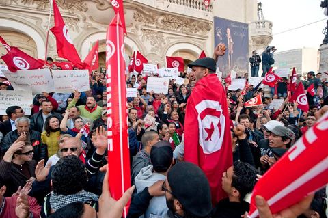 March 20, 2012: Nearly 6,000 Tunisians gathered Tuesday on Bourguiba Avenue in Tunis to celebrate Independence Day and “defend democracy” against “reactionary” forces, amid tensions fueled by the debate over identity and the role of religion.Tunisian flags were everywhere, horns blared, and the national anthem rang out: the demonstrators, who had come in response to calls on social media and from civic movements, chanted, “The people want a secular state!” “No to reactionary thinking, no to the caliphate,” or “We will not let obscurantist forces steal our revolution.”
The slogans of the revolution—“work, freedom, dignity”—were also chanted in unison. “In the name of the worker and the farmer, we continue to fight,” proclaimed one banner, while another demanded “jobs, or the government’s resignation.”  The 56th anniversary of independence—achieved on March 20, 1956, after 75 years of French protectorate rule—is taking place against a delicate backdrop, marked by growing tensions between the “Islamist” camp—which won the elections—and the “modernist” camp. The debate, exacerbated by incidents linked to Salafist radicals, centers on the question of Tunisian identity and the role religion should play in the country’s future constitution.