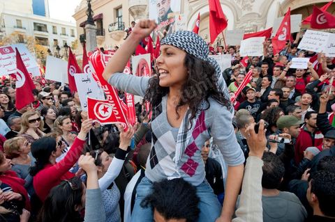 March 20, 2012: Nearly 6,000 Tunisians gathered Tuesday on Bourguiba Avenue in Tunis to celebrate Independence Day and “defend democracy” against “reactionary” forces, amid tensions fueled by the debate over identity and the role of religion.Tunisian flags were everywhere, horns blared, and the national anthem rang out: the demonstrators, who had come in response to calls on social media and from civic movements, chanted, “The people want a secular state!” “No to reactionary thinking, no to the caliphate,” or “We will not let obscurantist forces steal our revolution.”
The slogans of the revolution—“work, freedom, dignity”—were also chanted in unison. “In the name of the worker and the farmer, we continue to fight,” proclaimed one banner, while another demanded “jobs, or the government’s resignation.”  The 56th anniversary of independence—achieved on March 20, 1956, after 75 years of French protectorate rule—is taking place against a delicate backdrop, marked by growing tensions between the “Islamist” camp—which won the elections—and the “modernist” camp. The debate, exacerbated by incidents linked to Salafist radicals, centers on the question of Tunisian identity and the role religion should play in the country’s future constitution.