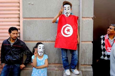 May 1, 2012, on Habib Bourguiba Avenue: Tunisian union members and workers march down the avenue to celebrate Labor Day. Children wearing Anonymous masks