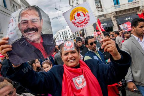 March 9, 2013: A woman holding a portrait of Chokri Belaid on Habib Bourguiba Avenue in Tunis; nearly 3,000 protesters gathered to commemorate Women’s Day and the death of Chokri Belaid on February 6. Several political figures, civil society activists, and artists answered the call from the UGTT Women’s Commission and other feminist organizations.