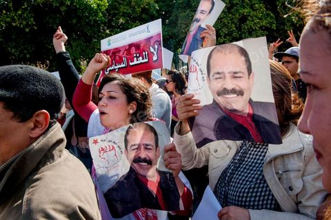 March 9, 2013: A woman holding a portrait of Chokri Belaid on Habib Bourguiba Avenue in Tunis; nearly 3,000 protesters gathered to commemorate Women’s Day and the death of Chokri Belaid on February 6. Several political figures, civil society activists, and artists answered the call from the UGTT Women’s Commission and other feminist organizations.
