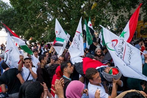 March 29, 2013: A highly tense standoff and minor clashes between pro-rebellion Syrians (three-red-star flag) and Tunisian activists from the pro-Bashar al-Assad Bass Party, with pro-Palestinian demonstrators in the middle brandishing a fake corpse in the central square of the WSF on the final day of the World Social Forum meetings on the Tunis university campus. This first forum held in the Arab world was strongly marked by Arab nationalist demands and observations, and dominated by a constant tribute to and support for the Palestinian people.