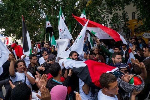 March 29, 2013: A highly tense standoff and minor clashes between pro-rebellion Syrians (three-red-star flag) and Tunisian activists from the pro-Bashar al-Assad Bass Party, with pro-Palestinian demonstrators in the middle brandishing a fake corpse in the central square of the WSF on the final day of the World Social Forum meetings on the Tunis university campus. This first forum held in the Arab world was strongly marked by Arab nationalist demands and observations, and dominated by a constant tribute to and support for the Palestinian people.