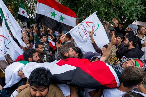March 29, 2013: A highly tense standoff and minor clashes between pro-rebellion Syrians (three-red-star flag) and Tunisian activists from the pro-Bashar al-Assad Bass Party, with pro-Palestinian demonstrators in the middle brandishing a fake corpse in the central square of the WSF on the final day of the World Social Forum meetings on the Tunis university campus. This first forum held in the Arab world was strongly marked by Arab nationalist demands and observations, and dominated by a constant tribute to and support for the Palestinian people.