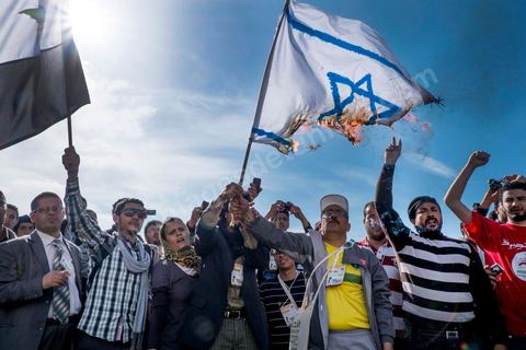 March 29, 2013: Tunisian activists from the “Bass pro Bashar al-Assad” party burned the Israeli flag in the central square of the World Social Forum on the final day of the World Social Forum meetings on the Tunis university campus. This first forum held in the Arab world was strongly marked by Arab nationalist demands and statements, and dominated by a constant tribute to and support for the Palestinian people.