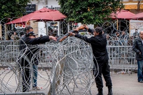 9 avril 2013 : un policier récupère les fusils de chevrotine aux policiers pour les remettre au ministrère de l'Intérieur, dispositif sécuritaire, la police sépare les deux côtés de l'avenue. à l'occasion de la journée des martyrs, l'avenue Bourguiba à Tunis a accueilli plusieurs marches politiques. Entre la première marche de la nouvelle alliance politique "Union pour la Tunisie", regroupant les partis progressistes Nidaa Tounes, Al Joumhouri, Al Massar, Parti Socialiste et Parti Patriotique, et celle des partisans de Ennahdha et des Ligues de Protection de la Révolution (LPR) la tension a été au maximum mais contrôlé par un dispositif sécuritaire impotant et efficace.