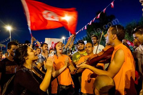 July 31, 2013: Amid the protesters, a mini-concert by the Atyists of the Movement of Revolutionary Creators. For the past four evenings, Tunisians have been gathering in the square in front of the National Assembly in the Bardo neighborhood of Tunis. Surrounding the nightly sit-ins by striking members of parliament, the public has been gathering to express their discontent following the assassination of MP Mohamed Brahmi and eight soldiers at Jebel Chambi.