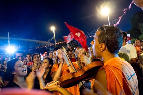 July 31, 2013: Amid the protesters, a mini-concert by the Atyists of the Movement of Revolutionary Creators. For the past four evenings, Tunisians have been gathering in the square in front of the National Assembly in the Bardo neighborhood of Tunis. Surrounding the nightly sit-ins by striking members of parliament, the public has been gathering to express their discontent following the assassination of MP Mohamed Brahmi and eight soldiers at Jebel Chambi.