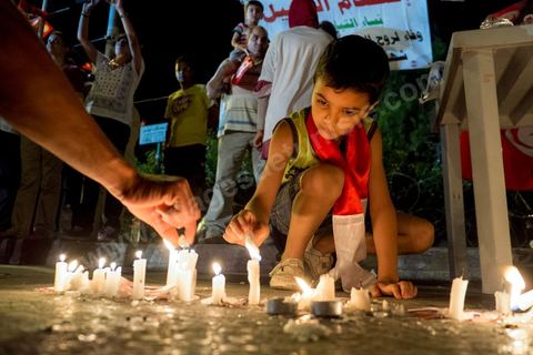 July 31, 2013: A candle in memory of the martyr Mohamed Brahim, who was assassinated on July 25. For the past four evenings, Tunisians have been gathering in the square in front of the National Assembly in the Bardo district of Tunis. Surrounding the nightly sit-ins held by striking members of parliament, the public has been gathering to express their outrage over the assassination of MP Mohamed Brahmi and eight soldiers at Jebel Chambi.