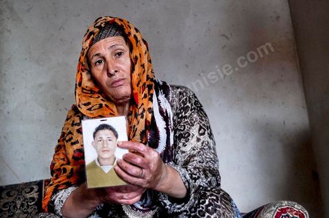 Janet, whose hands and neck are burned, shows us a photo of her missing son. At the home of Ahmed and Janet RIHIME in the Kabaria neighborhood. These parents have been searching for their 19-year-old son, Wissem, since March 2011. The tragedy struck this family twice when Janet, the mother, in a moment of despair, set herself on fire a few months ago.