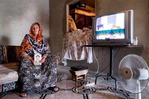 Janet, whose hands and neck are burned, shows us a photo of her missing son. At the home of Ahmed and Janet RIHIME in the Kabaria neighborhood. These parents have been searching for their 19-year-old son, Wissem, since March 2011. The tragedy struck this family twice when Janet, the mother, in a moment of despair, set herself on fire a few months ago.