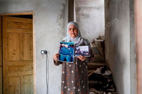 Rebh Bouthouri poses with a photo of her son Ibrahim, who went missing in March 2011. At the home of Ahmed and Janet RIHIME in the Kabaria neighborhood. These parents have been searching for their 19-year-old son, Wissem, since March 2011. The tragedy struck this family twice when Janet, the mother, in a moment of despair, set herself on fire a few months ago.