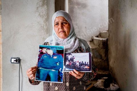 Rebh Bouthouri poses with a photo of her son Ibrahim, who went missing in March 2011. At the home of Ahmed and Janet RIHIME in the Kabaria neighborhood. These parents have been searching for their 19-year-old son, Wissem, since March 2011. The tragedy struck this family twice when Janet, the mother, in a moment of despair, set herself on fire a few months ago.