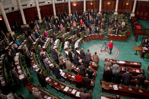 January 14, 2014: Members of the National Constituent Assembly sing the national anthem; they continue to review and vote on the articles of the constitution. On the anniversary of the Revolution, the president of the National Constituent Assembly had hoped to finalize the constitution on this commemorative day; unfortunately, heated debates are causing delays. 