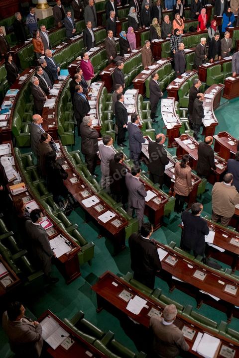 January 14, 2014: Members of the National Constituent Assembly sing the national anthem; they continue to review and vote on the articles of the constitution. On the anniversary of the Revolution, the president of the National Constituent Assembly had hoped to finalize the constitution on this commemorative day; unfortunately, heated debates are causing delays. 