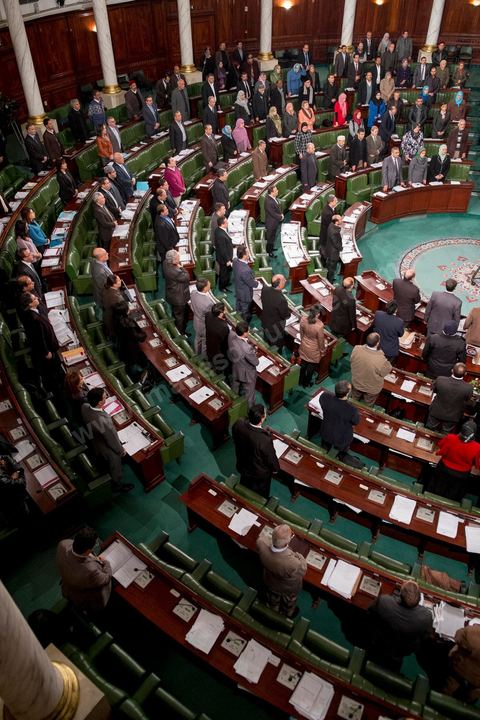 January 14, 2014: Members of the National Constituent Assembly sing the national anthem; they continue to review and vote on the articles of the constitution. On the anniversary of the Revolution, the president of the National Constituent Assembly had hoped to finalize the constitution on this commemorative day; unfortunately, heated debates are causing delays. 