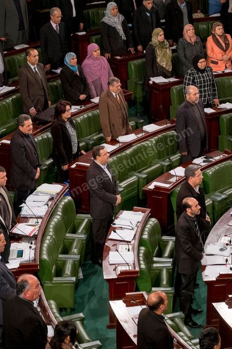 January 14, 2014: Members of the National Constituent Assembly sing the national anthem; they continue to review and vote on the articles of the constitution. On the anniversary of the Revolution, the president of the National Constituent Assembly had hoped to finalize the constitution on this commemorative day; unfortunately, heated debates are causing delays. 