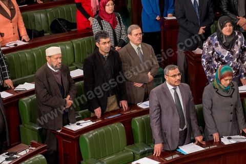 January 14, 2014: Members of the National Constituent Assembly sing the national anthem; they continue to review and vote on the articles of the constitution. On the anniversary of the Revolution, the president of the National Constituent Assembly had hoped to finalize the constitution on this commemorative day; unfortunately, heated debates are causing delays. 