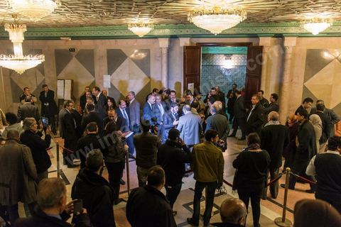 In front of the chamber, members of parliament speak with the media. On January 20, the Constituent Assembly adopted Article 73, which grants Tunisians with dual citizenship the right to run for president. This vote sparked a strong reaction from nationalist members of parliament.