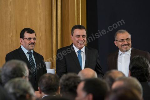 Ali and Ameur Laarayedh, standing on either side of Mehdi Jomaa during the handover ceremony for the position of Head of Government between Ali Laarayedh and Mehdi Jomaa at Dar Dhiafa on January 29, 2014.