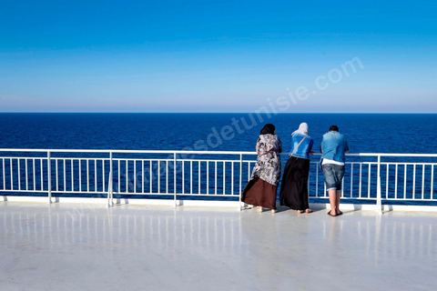 Passengers on the bridge in the approach of Tunisia. Aboard the new vessel Tanit de la CTN (Tunisian Company of Navigation) going Marseille to Tunis. The return of the Tunisian immigrants in France every summer represents a tourist and financial basket very important for Tunisia. The number of Tunisians of the foreigner would be close to 1,5 millions that is 13 % of the Tunisian population, are 60 % to be lived in France and 82 % in Europe, The summer represents 55 % of the 1,75 million Tunisians' annual entrances of the foreigner.