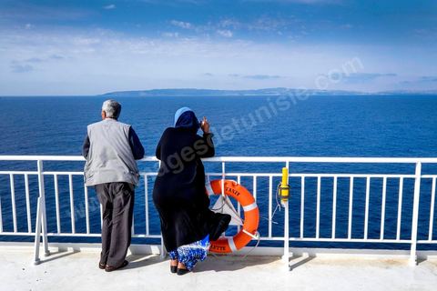 Passengers on the bridge in the approach of Tunisia. Aboard the new vessel Tanit de la CTN (Tunisian Company of Navigation) going Marseille to Tunis. The return of the Tunisian immigrants in France every summer represents a tourist and financial basket very important for Tunisia. The number of Tunisians of the foreigner would be close to 1,5 millions that is 13 % of the Tunisian population, are 60 % to be lived in France and 82 % in Europe, The summer represents 55 % of the 1,75 million Tunisians' annual entrances of the foreigner.