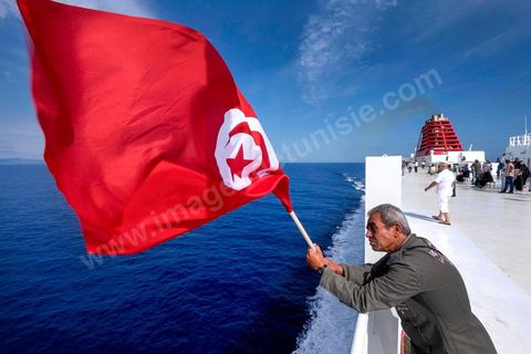 Passengers on the bridge in the approach of Tunisia. Aboard the new vessel Tanit de la CTN (Tunisian Company of Navigation) going Marseille to Tunis. The return of the Tunisian immigrants in France every summer represents a tourist and financial basket very important for Tunisia. The number of Tunisians of the foreigner would be close to 1,5 millions that is 13 % of the Tunisian population, are 60 % to be lived in France and 82 % in Europe, The summer represents 55 % of the 1,75 million Tunisians' annual entrances of the foreigner.