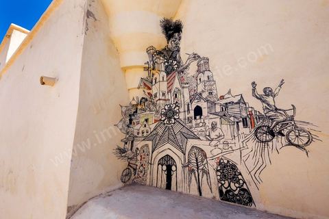Works by American artist SWOON for the DjerbaHood Project: after the Tour Paris 13, the Itinerrance team has set up shop in Erriadh, a traditional village on the island of Djerba. Since early July, the village of Erriadh has been gradually transforming into a veritable open-air museum. A selection of artists from around the world has been invited to showcase their work in this unique setting with its authentic architecture: white walls, turquoise-blue doors, domes, old buildings, and various abandoned sites—all offering endless possibilities that will give rise to unique creations imbued with local character.