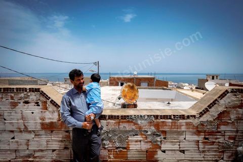 June 24, 2014: On the roof of Mohamed’s house in the medina of Ksibet, on the coast. Mohamed, a fishing boat captain in Ksibet El Mediouni near Monastir, smuggled hundreds of young undocumented migrants between Tunisia and Sicily between 1996 and 2002. Sentenced to six and a half years in prison, he has now resumed his work as a fishing boat captain. 