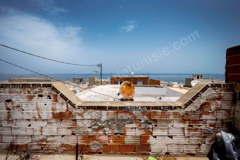 June 24, 2014: On the roof of Mohamed’s house in the medina of Ksibet, on the coast. Mohamed, a fishing boat captain in Ksibet El Mediouni near Monastir, smuggled hundreds of young undocumented migrants between Tunisia and Sicily between 1996 and 2002. Sentenced to six and a half years in prison, he has now resumed his work as a fishing boat captain. 