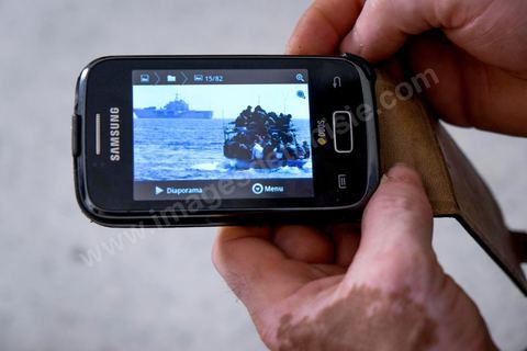 June 24, 2014: Mohamed shows a photo on his phone of an overcrowded boat he encountered at sea recently and which he reported to the Italian coast guard, who came to rescue them. Mohamed, a fishing boat captain in Ksibet El Mediouni near Monastir, smuggled hundreds of young undocumented migrants between Tunisia and Sicily between 1996 and 2002. Sentenced to six and a half years in prison, he has now returned to his job as a fishing boat captain. 