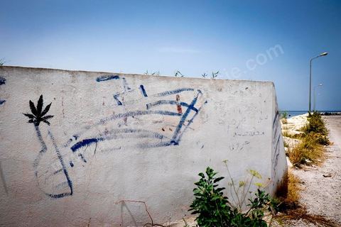June 24, 2014: Graffiti at the small port of Ksibet. Mohamed, a fishing boat captain in Ksibet El Mediouni near Monastir, smuggled hundreds of young undocumented migrants between Tunisia and Sicily between 1996 and 2002. Sentenced to six and a half years in prison, he has now returned to his work as a fishing boat captain. 
