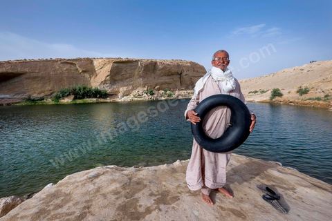 Belgacem came with some friends to go swimming in the lake at "Gafsa Beach." Since he didn't know how to swim, he made a float out of an inner tube.