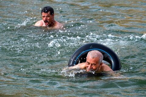 Belgacem came with some friends to go swimming in the lake at "Gafsa Beach." Since he didn't know how to swim, he made a float out of an inner tube.