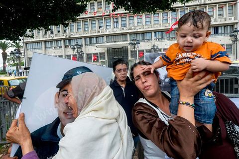 15 octobre 2014 : le fils, la femme et la mère de Mahamed Ali Snoussi. un sit-in devant le ministère de l'intérieur a rassemblé plusieurs dizaines de personnes, à l'appel de 27 organisations de la société civile, pour dénoncer les actes de torture policière en Tunisie. affichant des slogans tels que: "La torture est une atteinte à la dignité. La torture est un putsch contre la révolution" ou encore "La police torture et le ministère de l'intérieur dément". Manifestation organisée suite à la mort controversée de Mohamed Ali Snoussi en prison.