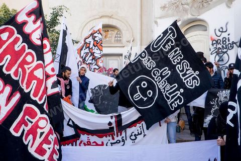January 14, 2015: About 50 young Islamists from the Kram League for the Protection of the Revolution came to wave banners reading “I am not Charlie” or “I am Muhammad.” Tunisians gathered on Habib Bourguiba Avenue in Tunis to celebrate the fourth anniversary of the Tunisian revolution, which led to the ouster of former President Zine el Abdidine Ben Ali on Friday, January 14, 2011, and his exile to Saudi Arabia. Among the many Tunisians who came to march with their families under mild sunshine, a wide variety of groups were scattered along the avenue: families of martyrs, supporters of Hizb ut-Tahrir, Ennahda, or El Watan, Islamist youth from the LPR, and supporters of Sofiane and Nadhir, ...