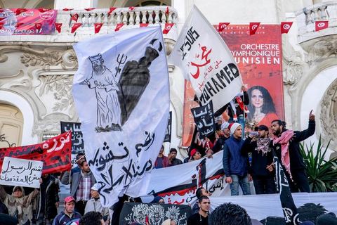 January 14, 2015: About 50 young Islamists from the Kram League for the Protection of the Revolution came to wave banners reading “I am not Charlie” or “I am Muhammad.” Tunisians gathered on Habib Bourguiba Avenue in Tunis to celebrate the fourth anniversary of the Tunisian revolution, which led to the ouster of former President Zine el Abdidine Ben Ali on Friday, January 14, 2011, and his exile to Saudi Arabia. Among the many Tunisians who came to march with their families under mild sunshine, a wide variety of groups were scattered along the avenue: families of martyrs, supporters of Hizb ut-Tahrir, Ennahda, or El Watan, Islamist youth from the LPR, and supporters of Sofiane and Nadhir, ...