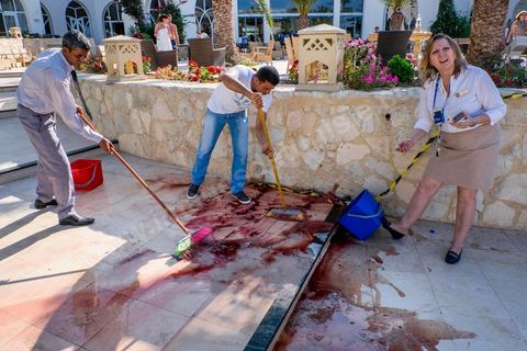 June 26, 2015: While shocked tourists continue to mill around the pool area, where hotel employees are cleaning up large amounts of blood.  Terrorist attack at a hotel in the tourist area of Port El Kantaoui, north of Sousse. A young Tunisian terrorist opened fire for nearly half an hour on tourists, from the hotel beach all the way to the reception area, leaving a preliminary death toll of 39 among tourists and Tunisian employees, before being shot dead by security forces. The Tunisian Ministry of Health states that among the injured are people of British, Belgian, German, and Norwegian nationalities, among others.