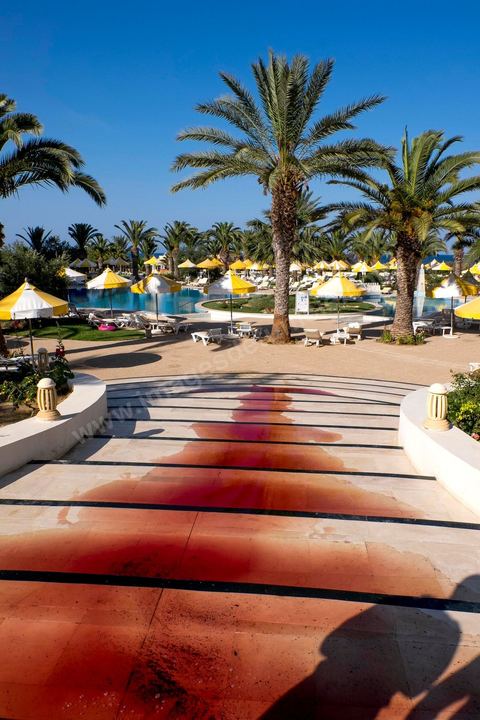 June 26, 2015: While shocked tourists continue to mill around the pool area, where hotel employees are cleaning up large amounts of blood.  Terrorist attack at a hotel in the tourist area of Port El Kantaoui, north of Sousse. A young Tunisian terrorist opened fire for nearly half an hour on tourists, from the hotel beach all the way to the reception area, leaving a preliminary death toll of 39 among tourists and Tunisian employees, before being shot dead by security forces. The Tunisian Ministry of Health states that among the injured are people of British, Belgian, German, and Norwegian nationalities, among others.