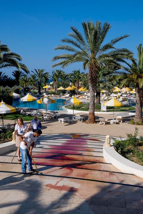 June 26, 2015: While shocked tourists continue to mill around the pool area, where hotel employees are cleaning up large amounts of blood.  Terrorist attack at a hotel in the tourist area of Port El Kantaoui, north of Sousse. A young Tunisian terrorist opened fire for nearly half an hour on tourists, from the hotel beach all the way to the reception area, leaving a preliminary death toll of 39 among tourists and Tunisian employees, before being shot dead by security forces. The Tunisian Ministry of Health states that among the injured are people of British, Belgian, German, and Norwegian nationalities, among others.