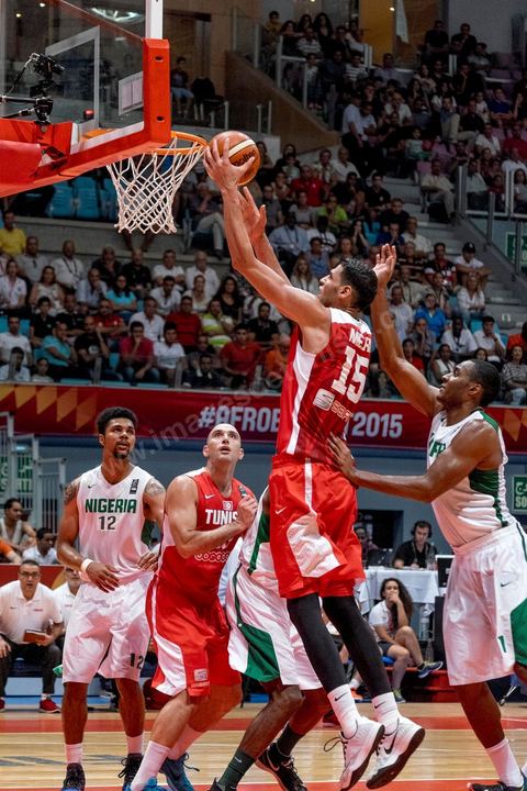 August 23, 2015: Salah Mejri, Tunisia’s famous No. 15, dominates the game at 2.17m; he has just been signed by the Dallas Mavericks and becomes the first Arab player in the NBA. Tunisia’s final group stage game against Nigeria at AfroBasket Tunisia 2015. Tunisia won (70–59) and finished first in its group.