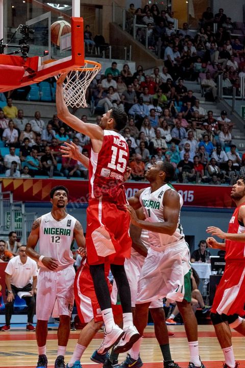 August 23, 2015: Salah Mejri, Tunisia’s famous No. 15, dominates the game at 2.17m; he has just been signed by the Dallas Mavericks and becomes the first Arab player in the NBA. Tunisia’s final group stage game against Nigeria at AfroBasket Tunisia 2015. Tunisia won (70–59) and finished first in its group.
