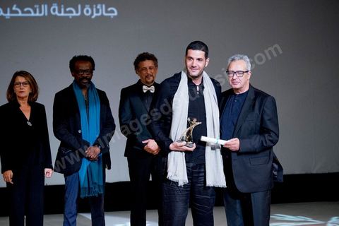 November 28, 2015: Brahim Eltaief, Director of the JCC, presents the Jury Prize to Nabil AYouch, the Moroccan director of the film "Much Loved." The closing ceremony of the JCC took place at the Municipal Theater of Tunis, in the heart of the capital, which had been devastated just a few days earlier by a suicide terrorist attack that killed 12 members of the presidential guard. The ceremony, moved up due to a curfew, served as a tribute to the culture that stood up to terror throughout the week and provided an opportunity to honor artists and filmmakers from the Arab-African world. 