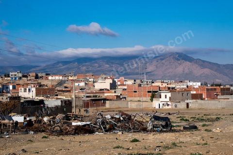 January 22, 2016: Between the famous working-class and revolutionary neighborhoods of Ezzouhour and Ennour on the hills above Kasserine, the neighborhoods continue to grow in a haphazard manner. The Karma neighborhood is one of the most deprived; its residents live amid piles of trash, and some are still waiting to be connected to the water supply. In the distance, Mount Chambi dominates the horizon, serving as a reminder of the presence and danger of terrorism.