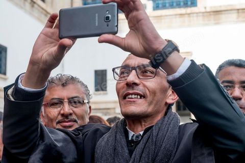 6 décémbre 2016 : Plus de 2.000 avocats ont manifesté mardi à Tunis contre les nouvelles dispositions fiscales qui leur ont été imposées dans le projet de budget 2017, actuellement examiné par le Parlement."Avec notre âme, avec notre sang nous défendrons le métier d'avocat", ont crié les manifestants en robe noire devant le siège du gouvernement à la Kasbah, dans le centre de Tunis, après une marche de quelques centaines de mètres."Les avocats sont en colère!", "Nous n'allons pas financer votre corruption", pouvait-on lire sur des pancartes brandies par les protestataires, dont beaucoup jugent les nouvelles mesures "injustes" et "inapplicables".En cause, des taxes imposées pour chaque dossier traité, pouvant être déduites de l'impôt sur le revenu et prévues dans le projet de loi de finances 2017.Ce mouvement ne fait toutefois pas l'unanimité, et sur les réseaux sociaux comme dans certains médias, les protestations des avocats ont été considérées comme une volonté de bénéficier d'un traitement spécial. Selon le webzine Inkyfada, qui a analysé des données officielles, 60% des avocats enregistrés n'ont pas déclaré d'impôts en 2015, et "les avocats en règle paient en moyenne 228 dinars (92 euros) d'impôt sur le revenu par mois".